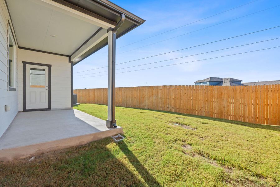 Fenced backyard with a patio area Fenced backyard with a patio area