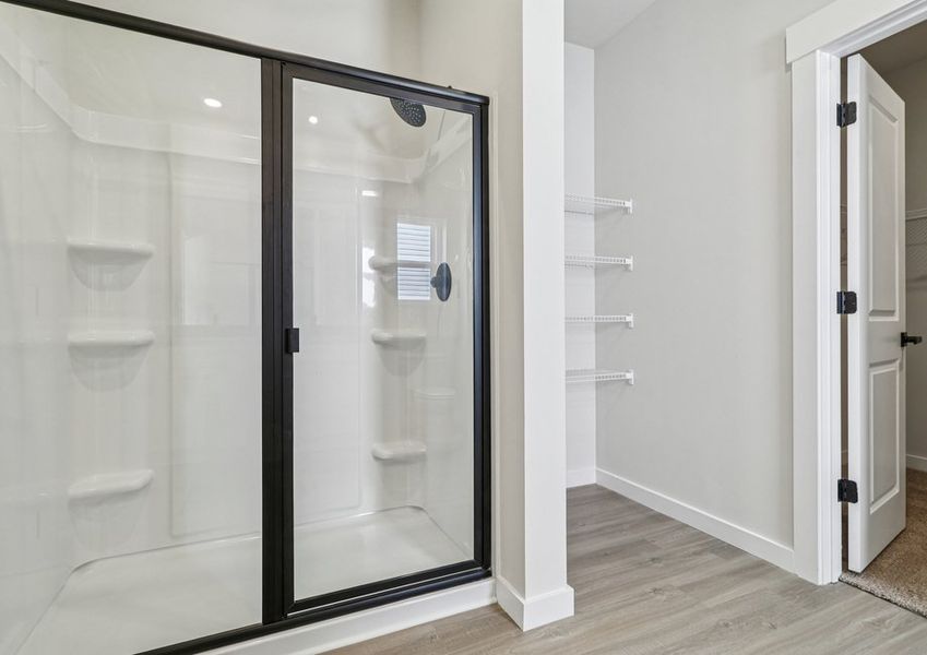 The master bathroom has a glass-enclosed shower.