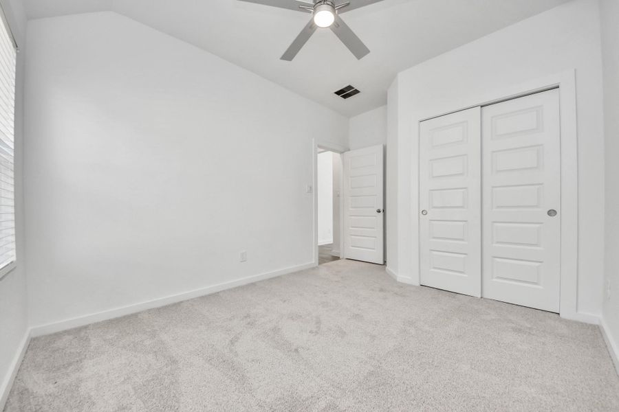Generously sized secondary bedrooms featuring spacious closets, soft and inviting carpeting underfoot, large windows allowing plenty of natural light, and the added touch of privacy blinds for your personal retreat.