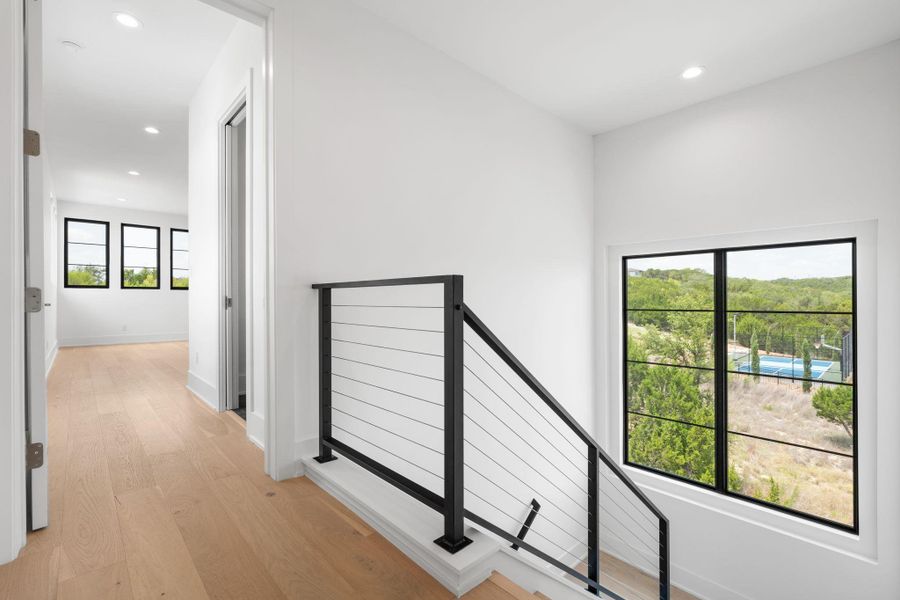 Clean lines define this bright interior with sleek cable railings and abundant natural light.