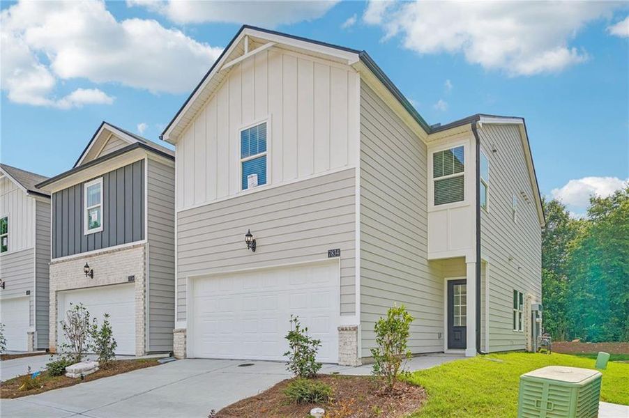 Front exterior of a new home in Artisan Walk, Fairburn, GA, highlighting curb appeal (Image 1). Front exterior of a new home in Artisan Walk, Fairburn, GA, highlighting curb appeal (Image 1).