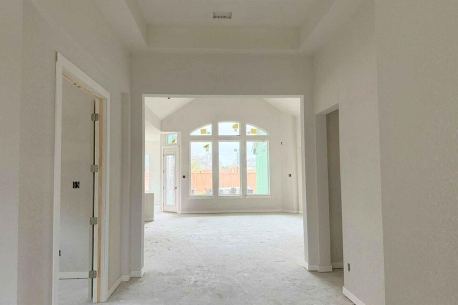 Hallway featuring a tray ceiling