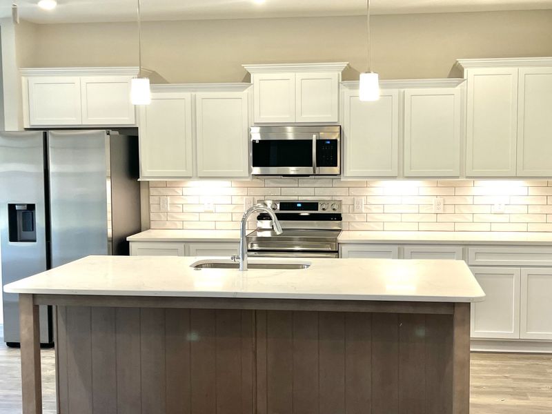 Stock: Wonderful textured backsplash highlighted by undercabinet lighting. Stock: Wonderful textured backsplash highlighted by undercabinet lighting.