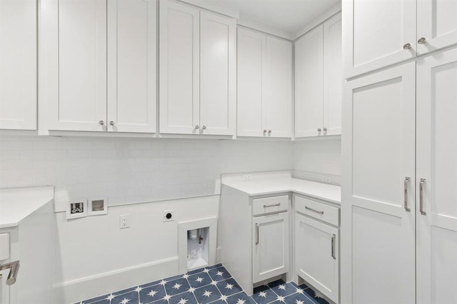 Laundry room featuring hookup for a washing machine, cabinet space, and electric dryer hookup Laundry room featuring hookup for a washing machine, cabinet space, and electric dryer hookup