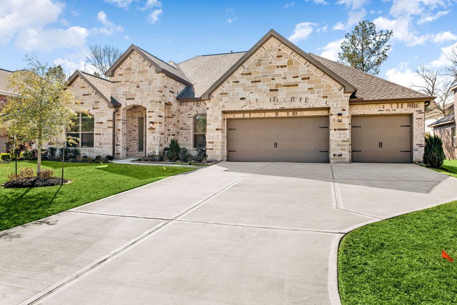 Front exterior of a new home in Stewart’s Forest, Conroe, TX, highlighting curb appeal (Image 1).