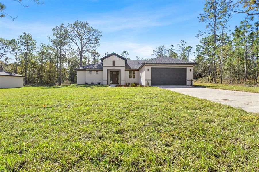 Front exterior of a new home in , Weeki Wachee, FL, highlighting curb appeal (Image 31). Front exterior of a new home in , Weeki Wachee, FL, highlighting curb appeal (Image 31).