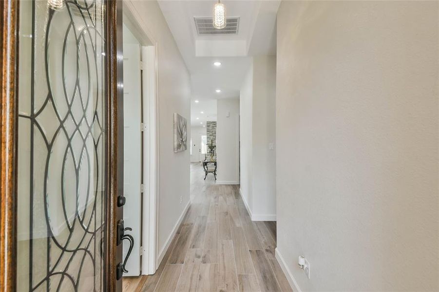 Beautiful beveled glass and wood front door welcomes guests.