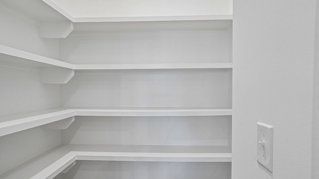 Spacious Walk-In Pantry with Upgraded Built-In Shelving Standard!