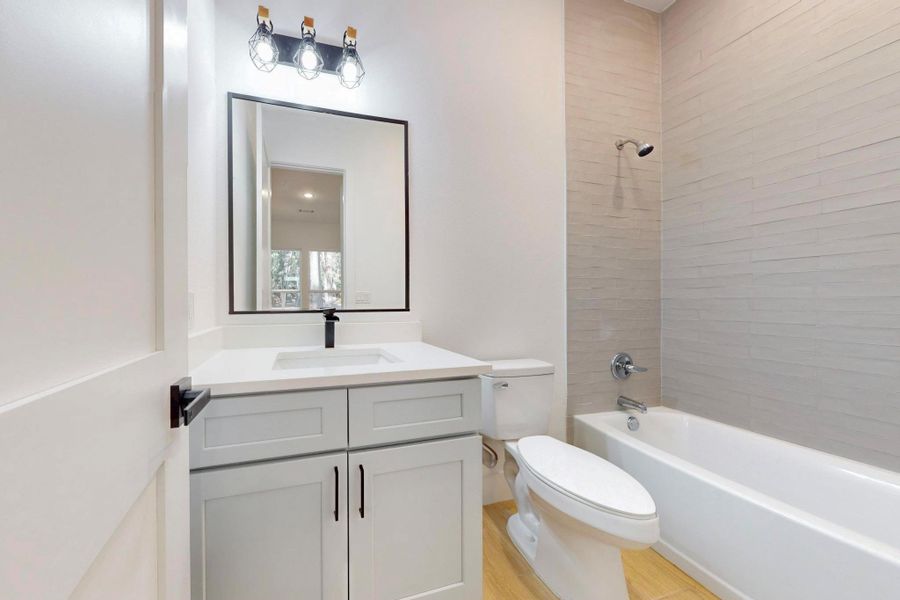 Bathroom featuring vanity and shower / bathtub combination