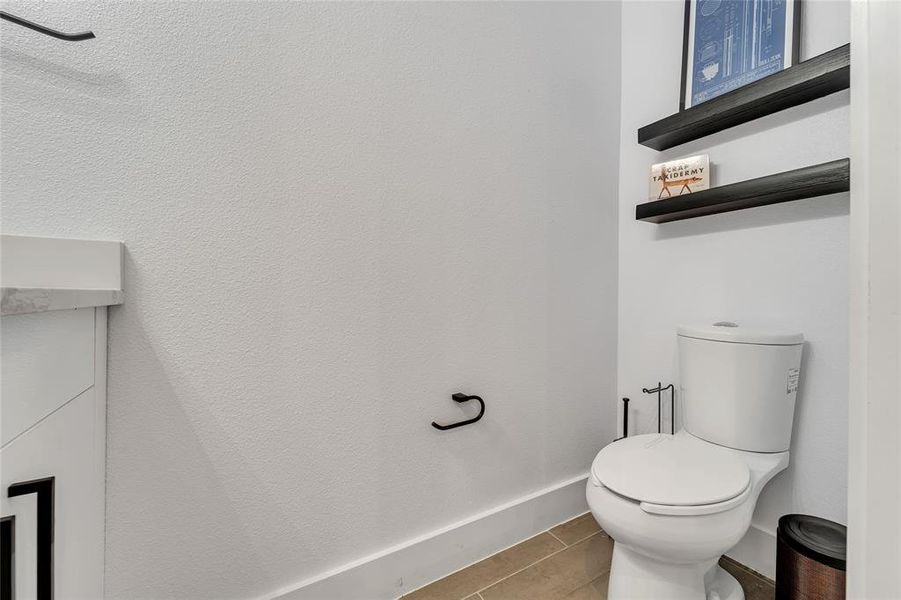 Bathroom with toilet and tile patterned floors Bathroom with toilet and tile patterned floors