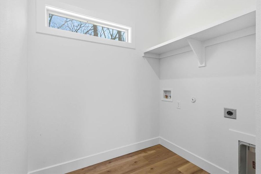 A bright place to do laundry with shelving!