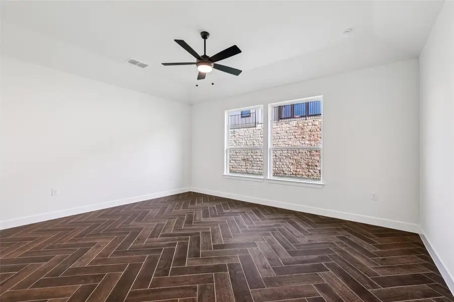 Unfurnished room with baseboards and a ceiling fan