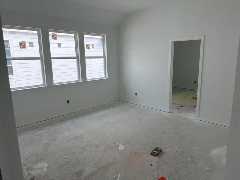 Unfurnished bedroom with vaulted ceiling
