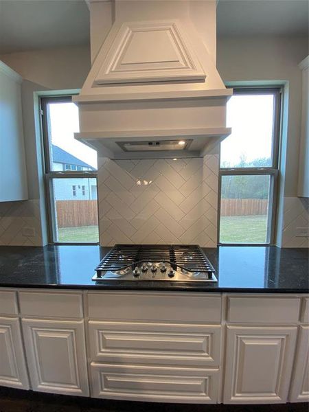 Built-in gas 5 burner cooktop with custom cabinet vent hood to outside Built-in gas 5 burner cooktop with custom cabinet vent hood to outside