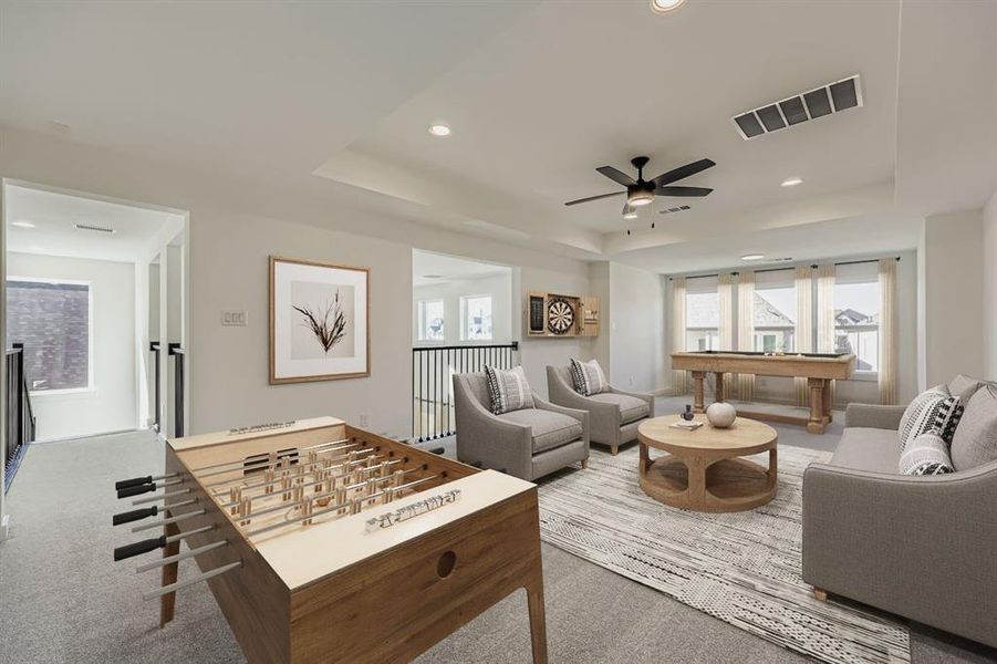 Virtually staged photo - Living area with a tray ceiling, light colored carpet, ceiling fan, billiards table, and recessed lighting