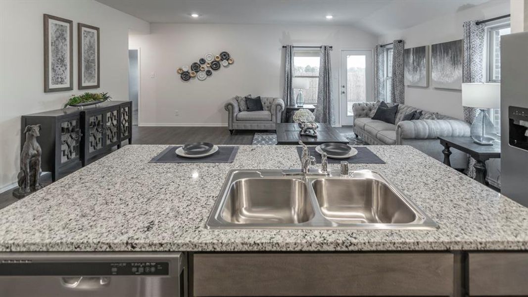 Kitchen with open floor plan, a kitchen island with sink, stainless steel appliances, dark wood finished floors, and recessed lighting