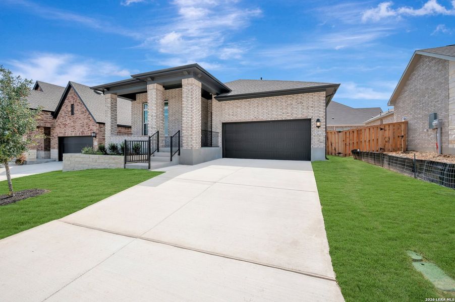 Front exterior of a new home in Windsong - Reserve Series, Boerne, TX, highlighting curb appeal (Image 1). Front exterior of a new home in Windsong - Reserve Series, Boerne, TX, highlighting curb appeal (Image 1).
