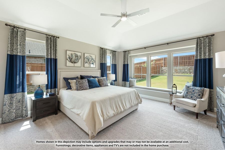 Spacious master bedroom with vaulted ceiling, ceiling fan, large windows, and carpet flooring Spacious master bedroom with vaulted ceiling, ceiling fan, large windows, and carpet flooring