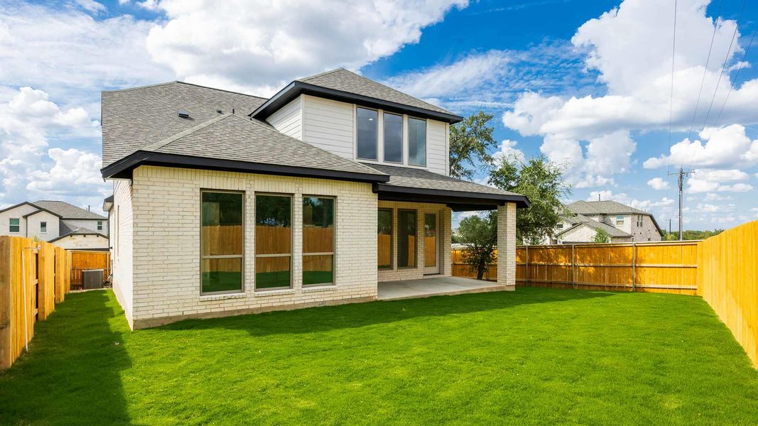 Rear view of property featuring a shingled roof, a patio, brick siding, and a fenced backyard Rear view of property featuring a shingled roof, a patio, brick siding, and a fenced backyard