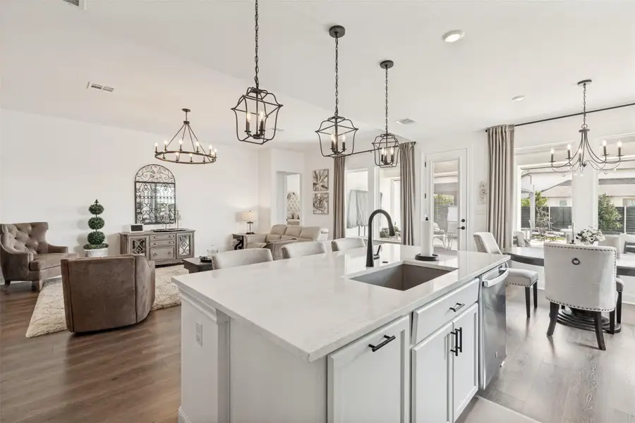 An open concept floorplan seamlessly connects the stone counters to the living areas.