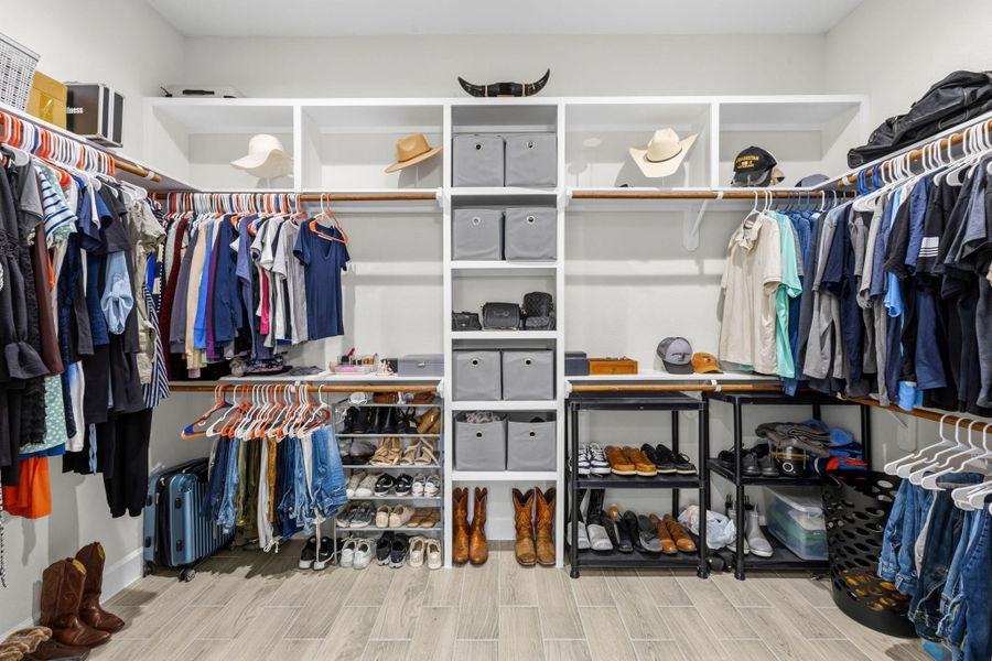 PRIMARY CLOSET - Spacious walk in closet with built ins.