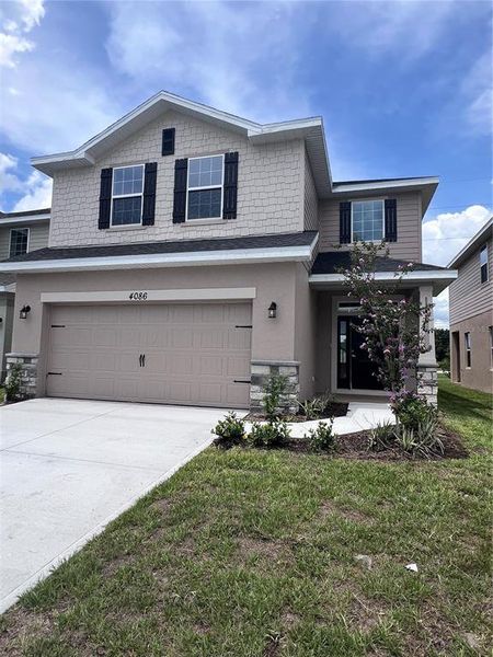Front exterior of a new home in Harmony Central, Harmony, FL, highlighting curb appeal (Image 10). Front exterior of a new home in Harmony Central, Harmony, FL, highlighting curb appeal (Image 10).