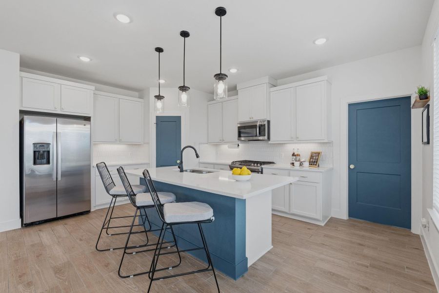 What a fun kitchen in this open concept lay out. Door to the right leads to laundry room.