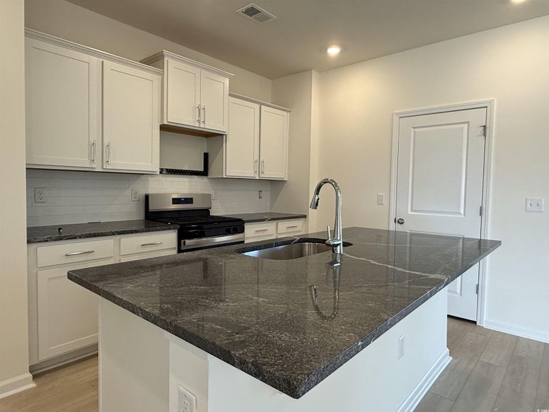 Unfurnished room with ceiling fan and wood finished floors Unfurnished room with ceiling fan and wood finished floors