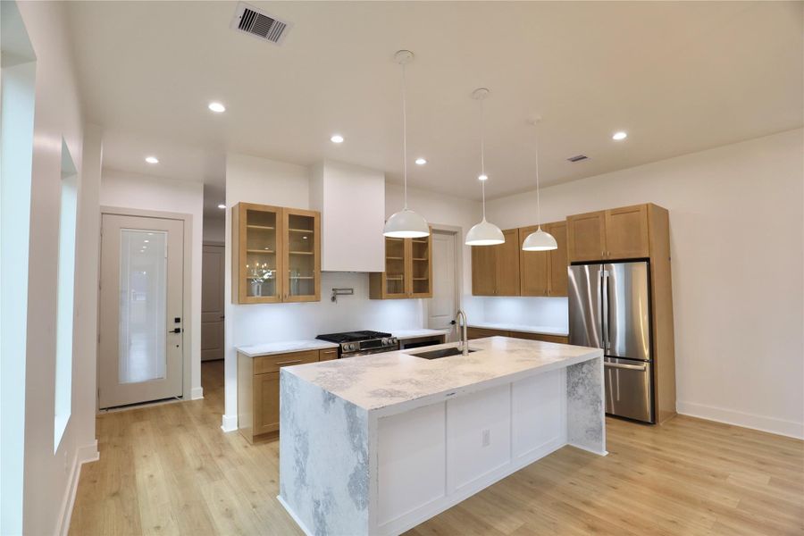 This bright and airy kitchen is adorned with sleek, modern finishes, under-cabinet lighting, and thoughtful upgrades throughout. The walk-in pantry offers a well-designed space for ultimate convenience. This bright and airy kitchen is adorned with sleek, modern finishes, under-cabinet lighting, and thoughtful upgrades throughout. The walk-in pantry offers a well-designed space for ultimate convenience.