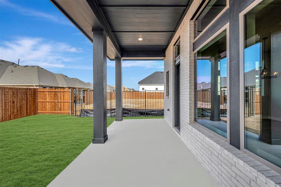 Fenced backyard with a patio area