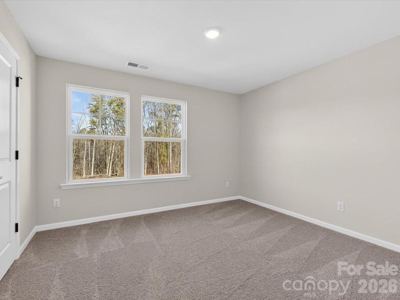 secondary bedroom has views of the trees