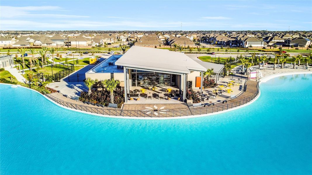 A sweeping aerial view highlights the lagoon and amenity spaces, emphasizing the community’s resort-style atmosphere.