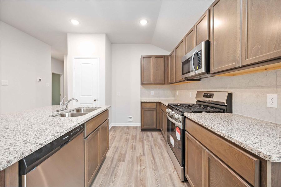 Stainless appliances, gorgeous counters, and cabinet space galore! YES PLEASE!