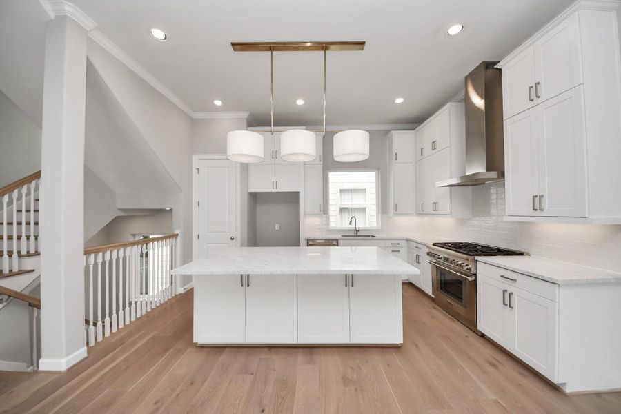 Alternate view of the kitchen showcasing custom cabinetry, premium finishes, and open-concept design. Alternate view of the kitchen showcasing custom cabinetry, premium finishes, and open-concept design.