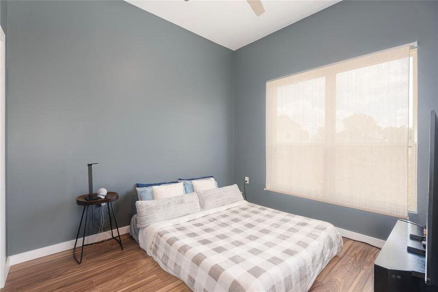 Bedroom with wood finished floors and ceiling fan Bedroom with wood finished floors and ceiling fan