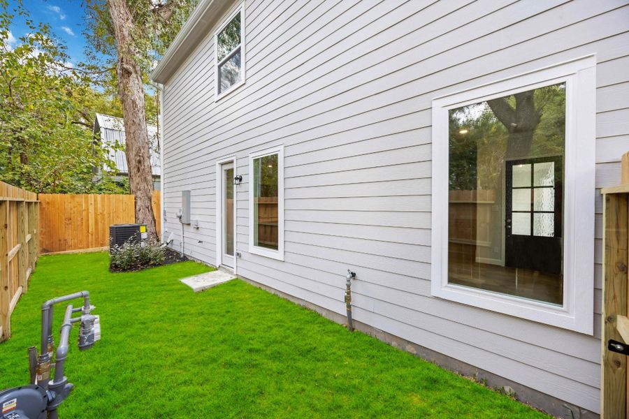 A rare find for this location: a fully fenced, grassy yard with room to play, garden, or let pups roam—plus easy access from inside for everyday living and entertaining.