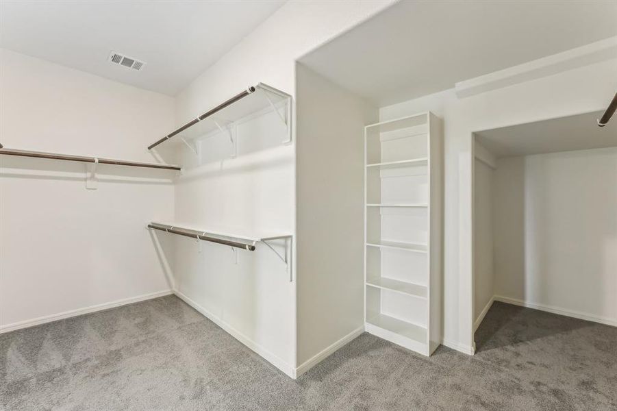 Discover this dream walk-in closet! This spacious closet provides a place for everything.