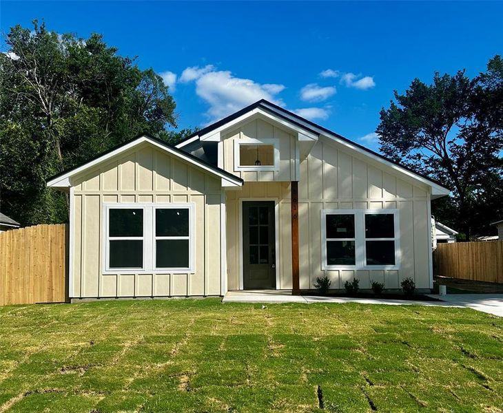 Contemporary single-story residence featuring board and batten siding