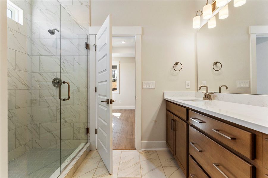 This bright bathroom features a spacious shower an This bright bathroom features a spacious shower an