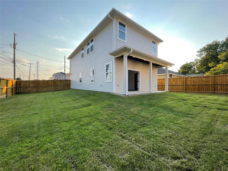 Back of property featuring a patio and a fenced backyard