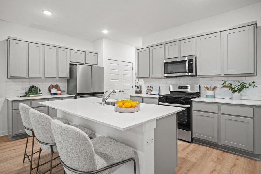 Kitchen in the Oak home plan by Trophy Signature Homes – REPRESENTATIVE PHOTO