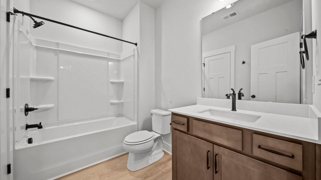 A hardwood-finished basement that blends comfort, function, and entertainment perfectly