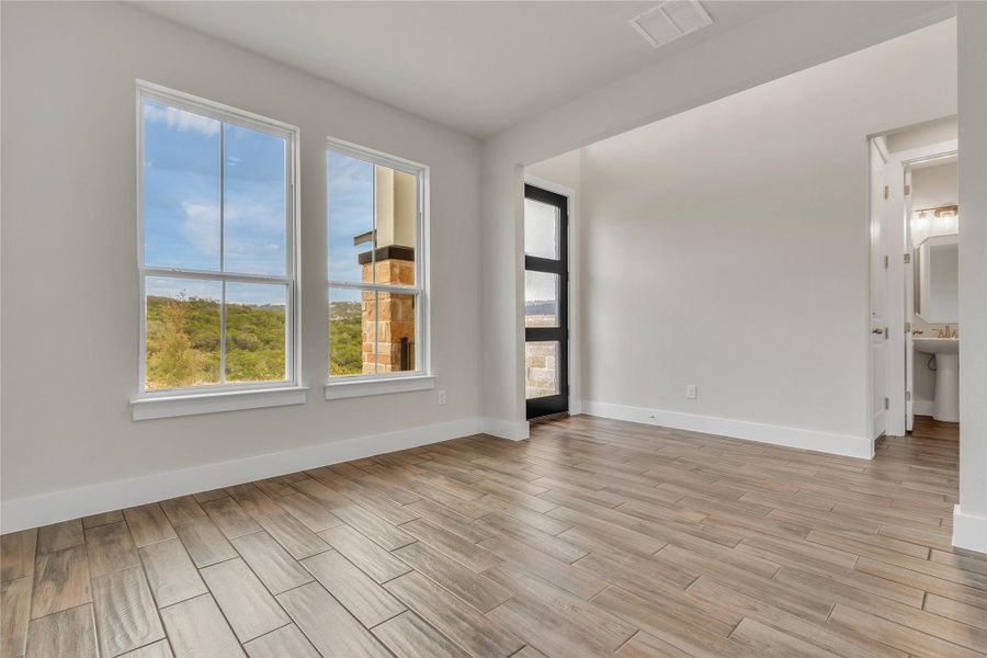 Ample natural illumination floods this versatile space, perfect for an office or additional living area.
