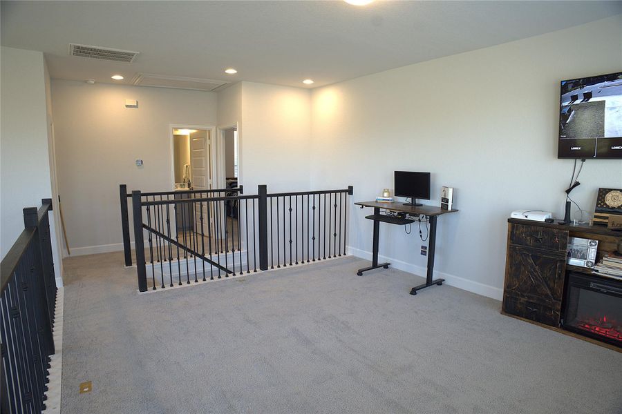 Office area with carpet flooring and recessed lighting Office area with carpet flooring and recessed lighting