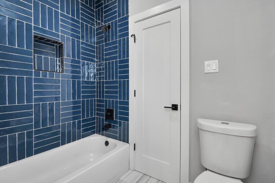 Stylish bathroom with bold tile accents and modern fixtures. Clean design with a fresh, contemporary feel.