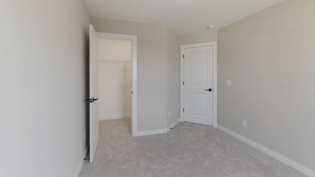 Bedroom with carpet and closet