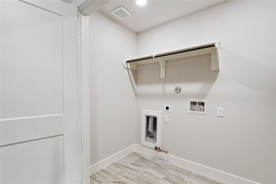 A dedicated laundry space adds everyday convenience with room to keep routines organized and out of sight. With clean finishes and extra storage potential, it’s a functional touch that makes daily living feel effortless.