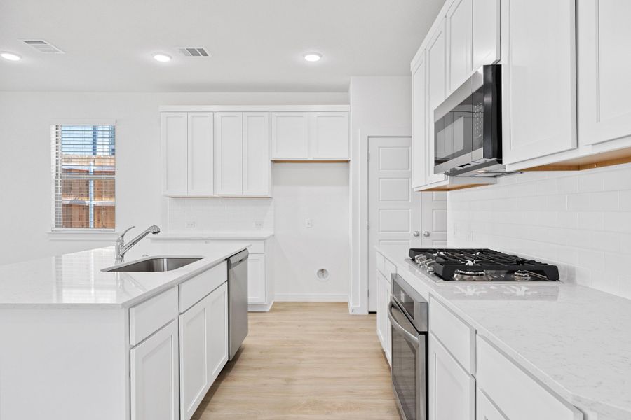 Kitchen in the Oak home plan by Trophy Signature Homes – REPRESENTATIVE PHOTO Kitchen in the Oak home plan by Trophy Signature Homes – REPRESENTATIVE PHOTO