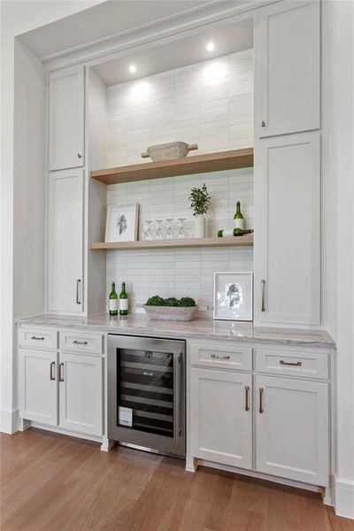 Bar area is equipped with a sub-zero beverage fridge.