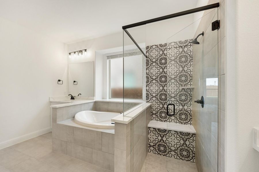Bathroom with soaking tub, glass walk-in shower, and decorative patterned tile accent wall